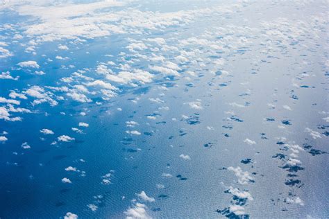 clouds   pacific ocean   airplane  stock photo picjumbo