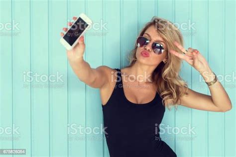 Blonde Woman In Bodysuit With Perfect Body Taking Selfie Smartphone