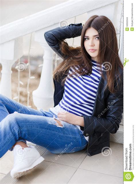 Portrait Of A Beautiful Woman Sitting On The Steps Stock