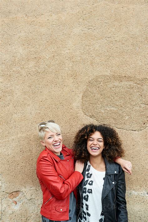 attractive girlfriends laughing together by stocksy contributor