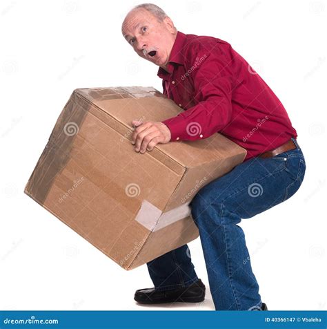 senior man carries  heavy box stock photo image