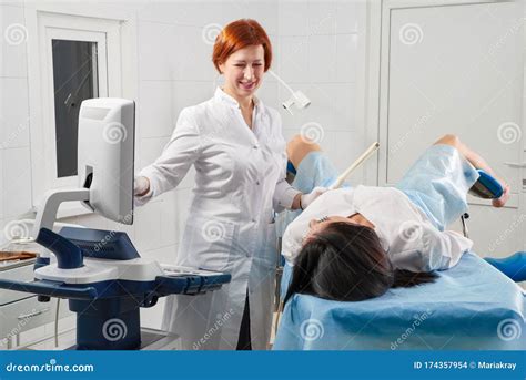 Gynecologist Holding Trans Vaginal Ultrasound Wand To Exam A Woman