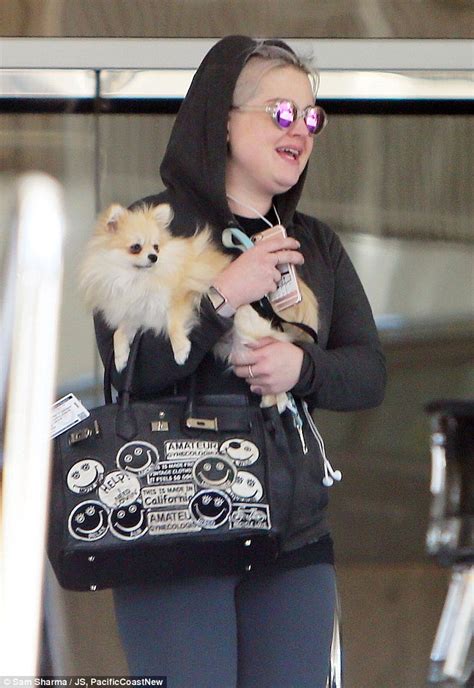 kelly osbourne cradles her teacup pomeranian polly as she steps out in