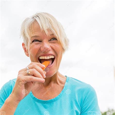 Mature Woman Bites In A Carrot Stock Image Image Of Adorable Carrot