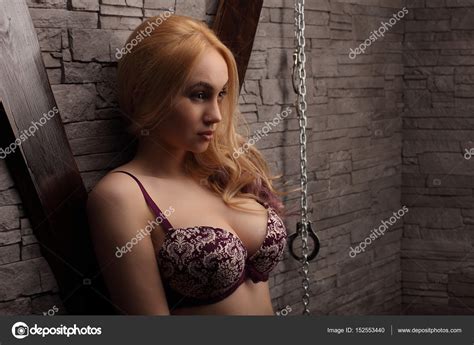 blond slim woman with big boobs standing in lingerie near