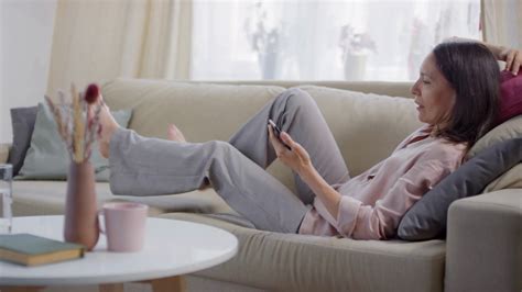 sequence of shots footage of relaxed woman relaxing on sofa consulting