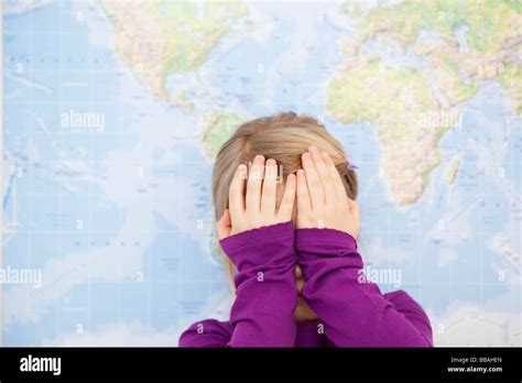 young girl hiding face  hands stock photo alamy