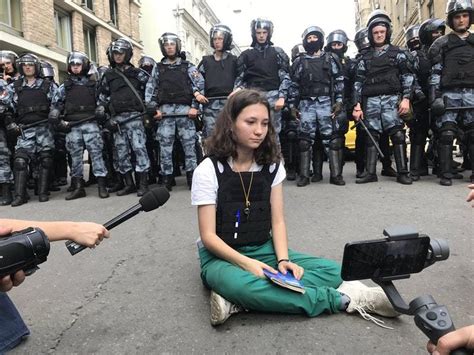 viral photo shows teenage girl reading russian constitution to riot