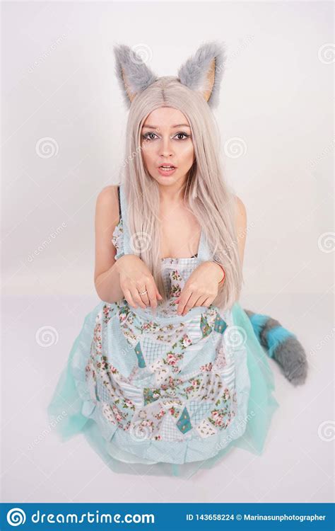 Funny Girl With Fluffy Fur Cat Ears Stands In A Kitchen