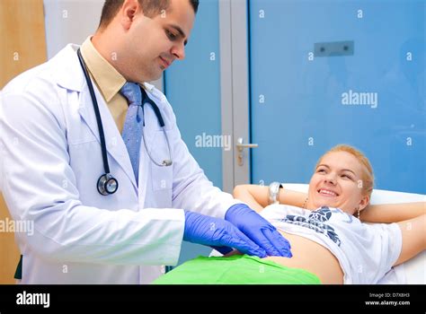 The Doctor Examines The Patients Abdomen Doctor And Patient Shoot A