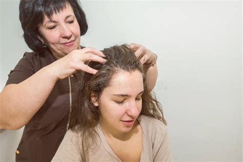 Masseuse Doing Massage Of The Girl`s Head In The Massage Parlor Stock