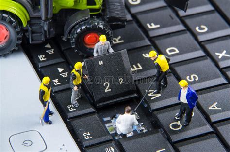 tiny toys team  engineers repairing keyboard computer