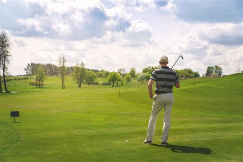 golfspeler die zich op het het zetten groene het letten op gat bevinden stock foto image