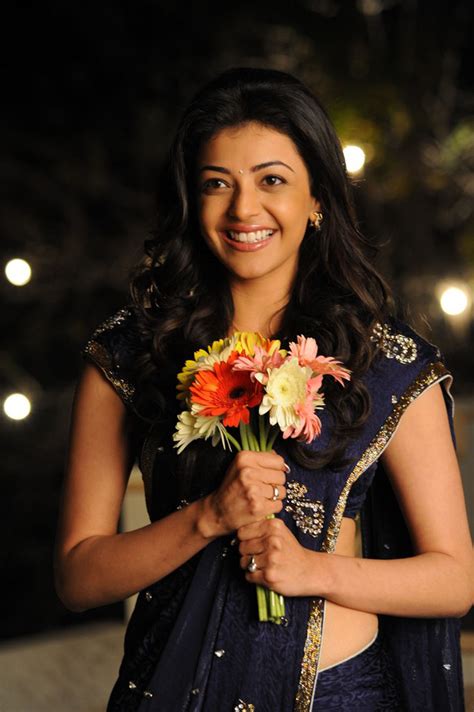sizzling hot celebs from india saree donning kajal with flowers in her hands