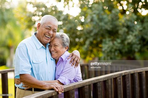 mexican senior couple laughing on bridge high res stock