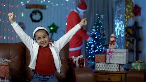 pretty indian girl is really excited after seeing santa at her