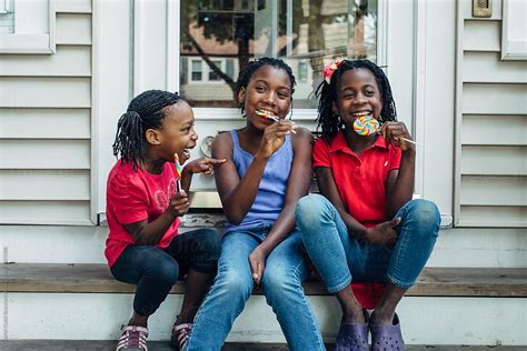 three silly black girls with lollipops on steps by gabriel gabi