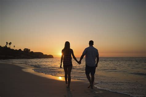 couple holding hands while walking on beach couples couples walking