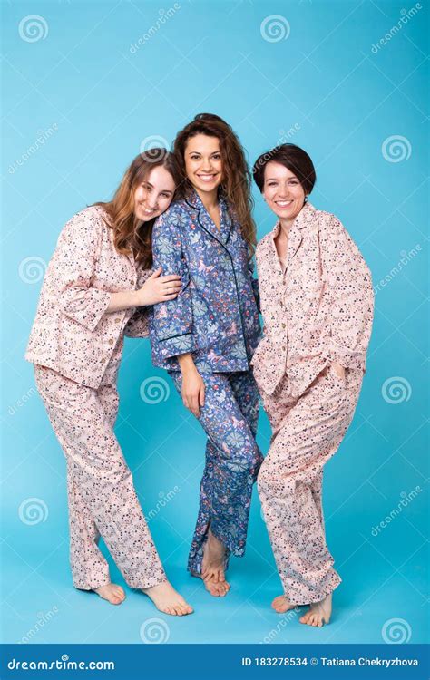 Portrait Of Three Beautiful Young Girls Wearing Colorful Pyjamas Having
