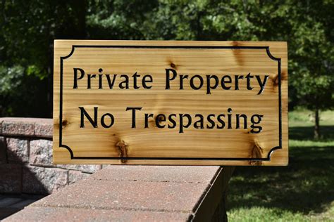 carved wood sign  trespassing sign outdoor sign   property stay safe