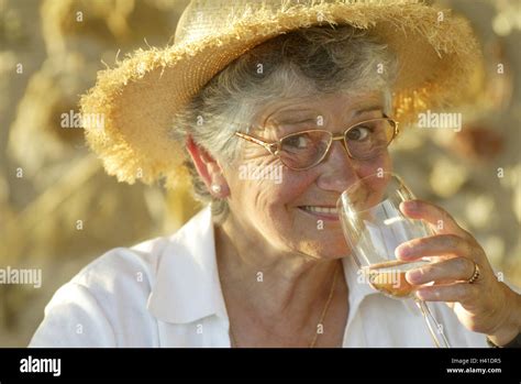 senior straw hat wineglass smile drink portrait curled 60 70