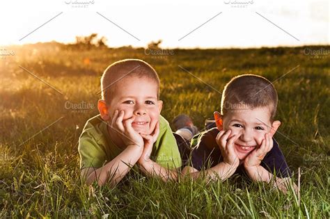 Two Brothers Lying On Grass ~ People Photos On Creative Market