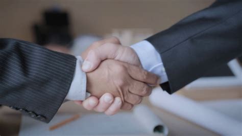 manager shaking hands with colleague after business meeting for
