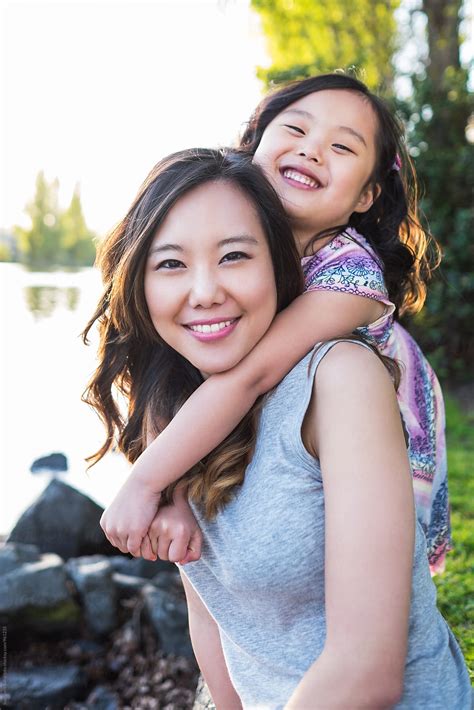 happy asian mother and daughter having fun together by stocksy