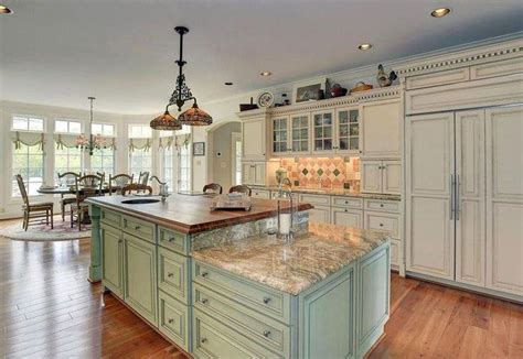 country kitchen with light green two tier island with butcher block