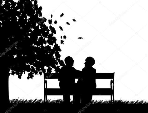lovely retired elderly couple sitting on bench in park in