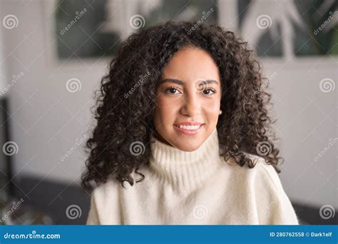 Young Smiling Latin Woman Posing At Home Looking At Camera Portrait