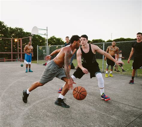 young men playing street basketball