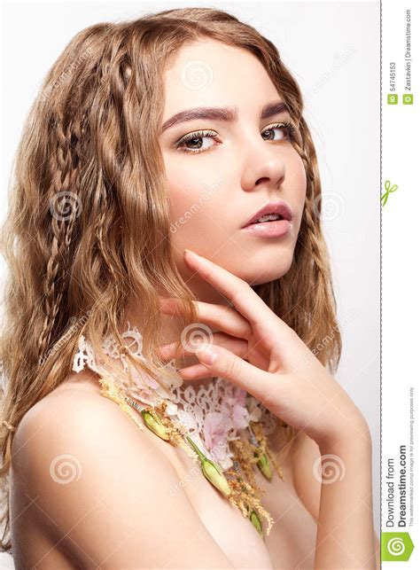close up portrait of teen girl with flower necklace stock