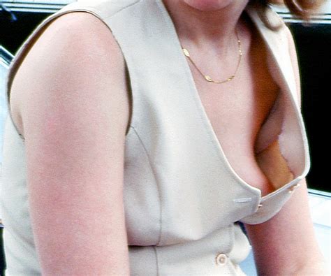 exhibitionist milf braless in an open vest top worn in public