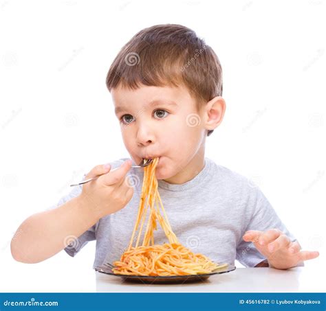 boy  eating spaghetti stock photo image