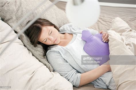 woman sleeping with hot water bottle photo getty images