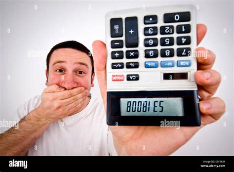 man holds   calculator upside    words boobies written   numbers stock