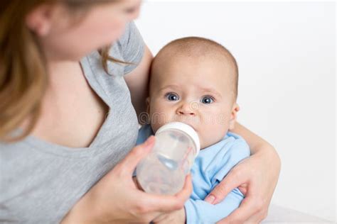 mother feeding baby  bottle stock photo image  childhood infant