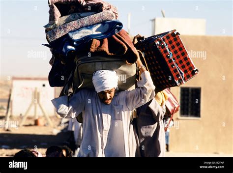 refugee man carrying   luggage  gulf crisis stock photo alamy