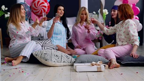 A Group Of Dancing Girls At A Pajama Party With Glasses Of Champagne