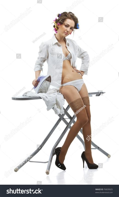 Beautiful Sexy Woman Ironing Clothes Against Bright