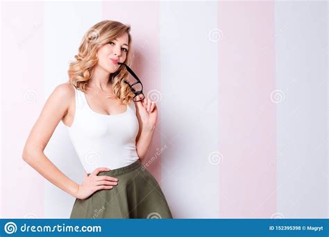 Cute Natural Blonde Woman With Glasses Looking At Camera While Standing
