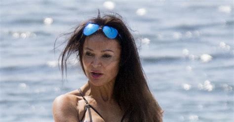 lizzie cundy gets very cheeky in tiny string bikini showing off her