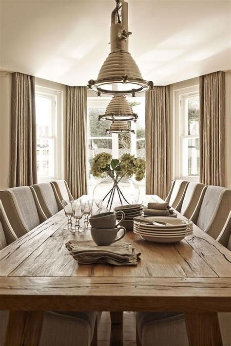 taupe dining room features  long reclaimed wood dining