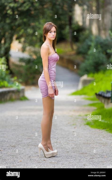 elegant model teen girl female standing posing in park stilettos stock