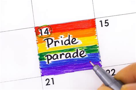 Woman Fingers With Pen Writing Reminder Pride Parade In Calendar Stock