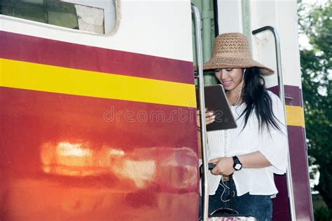 Pretty Asian Traveler Female Looking Tablet On A Train Stock Image