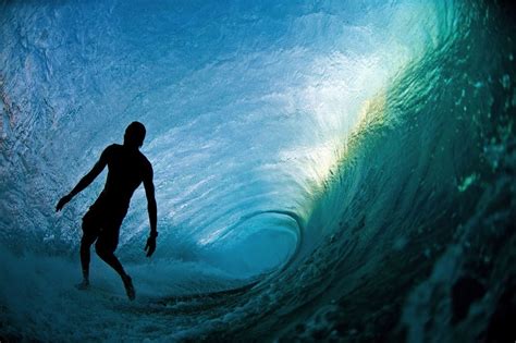 clark little swims into giant ocean waves to capture
