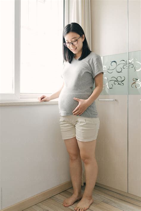 portrait of chinese pregnant woman by stocksy contributor maahoo