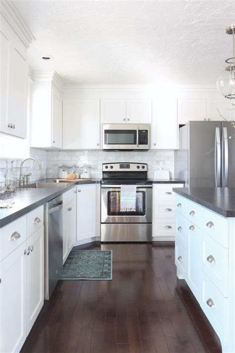 white shaker kitchen cabinets blue island marble backsplash black countertops